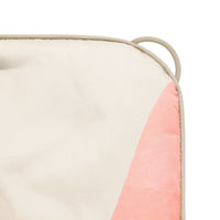 Puffy blanket with cream base and pink geometric triangle design, corner view showing handle detail