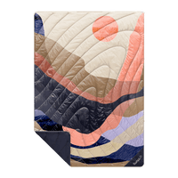 Quilted outdoor blanket with abstract curved pattern in coral, navy, cream and purple tones