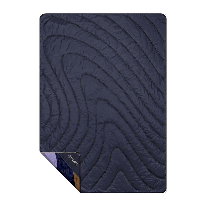 Navy blue quilted outdoor blanket with curved stitching pattern laid flat on white background