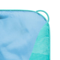 Corner detail of puffy blanket with blue to teal gradient pattern and fabric loop handle