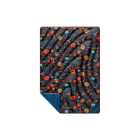 Compact puffy blanket with space-themed doodle print featuring planets and UFOs, corner folded to reveal solid navy lining