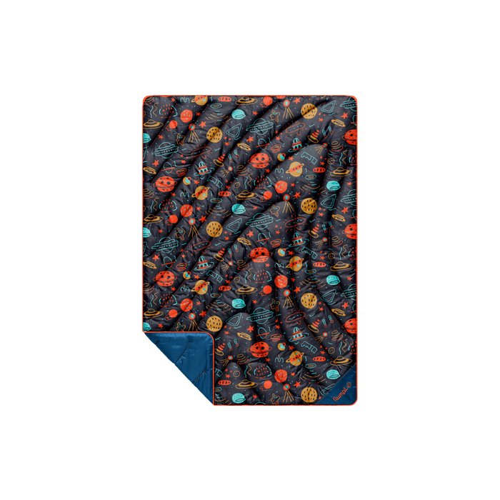 Compact puffy blanket with space-themed doodle print featuring planets and UFOs, corner folded to reveal solid navy lining