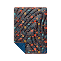 Puffy quilted blanket with space-themed doodle print, navy blue reverse side visible at folded corner