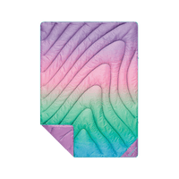 Quilted puffer blanket with rainbow ombre gradient pattern, corner folded back showing solid purple reverse side