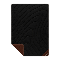Black quilted camping blanket with diagonal stitching pattern and brown corner accents, flat lay view