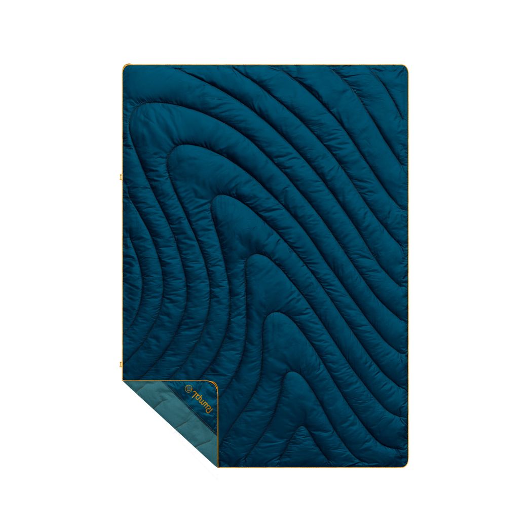 Navy quilted puffy blanket with curved wave stitching pattern and sage green corner fold