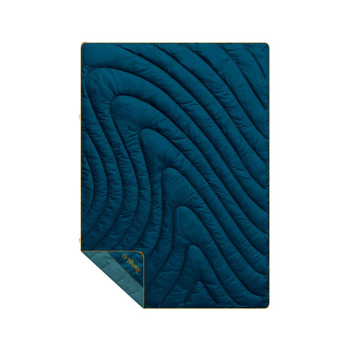 Navy quilted puffy blanket with curved wave stitching pattern and sage green corner fold