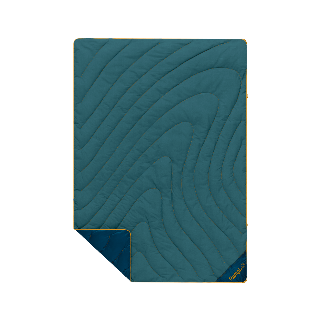 Quilted puffy blanket with curved topographic pattern in teal green, corner folded to show navy backing