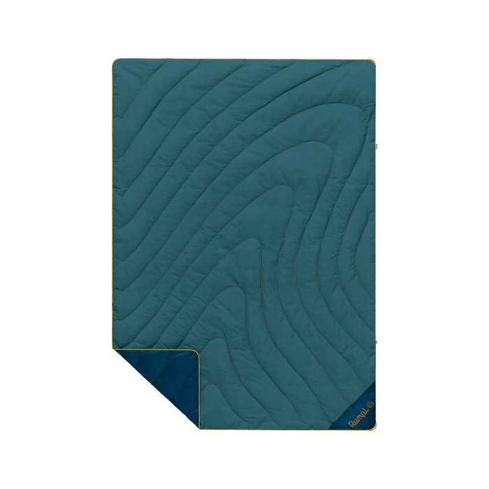 Quilted puffy blanket with curved topographic pattern in teal green, corner folded to show navy backing
