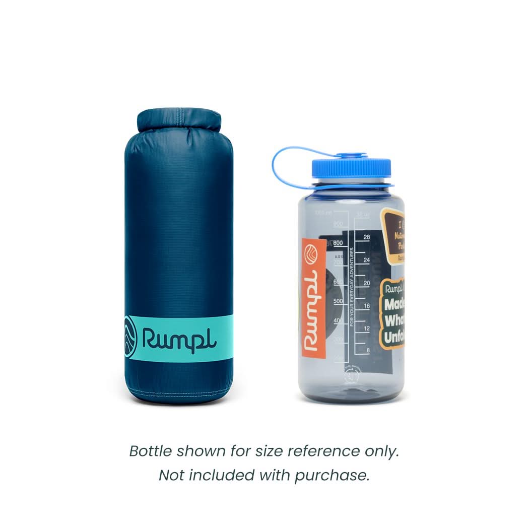 Compact rolled travel blanket in carry sack beside water bottle for size reference