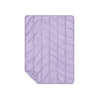 Light purple quilted travel blanket with wave stitching pattern, flat lay view
