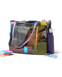Iridescent mesh tote bag with purple handles and colorful accessories, styled with books and goggles