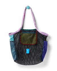 Mesh tote bag with colorful fabric panels and shoulder straps hanging against white background