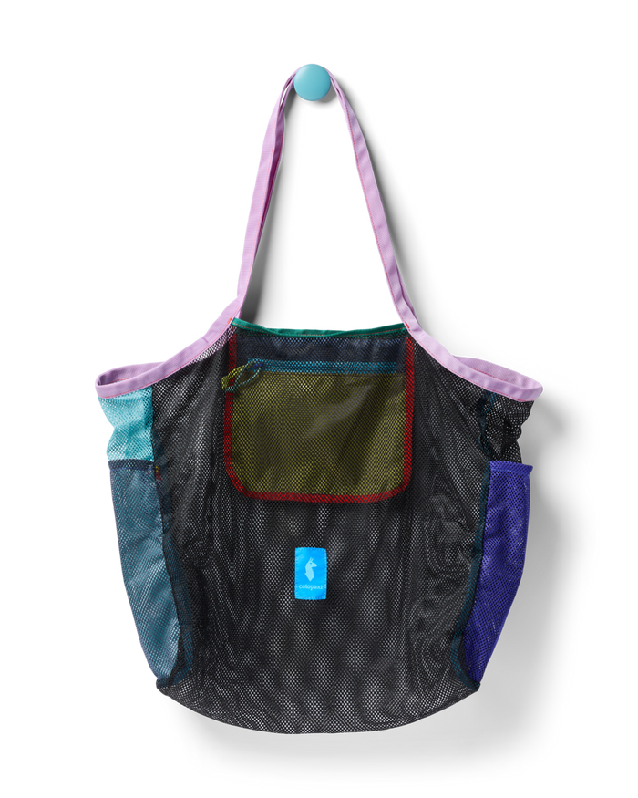 Mesh tote bag with colorful fabric panels and shoulder straps hanging against white background
