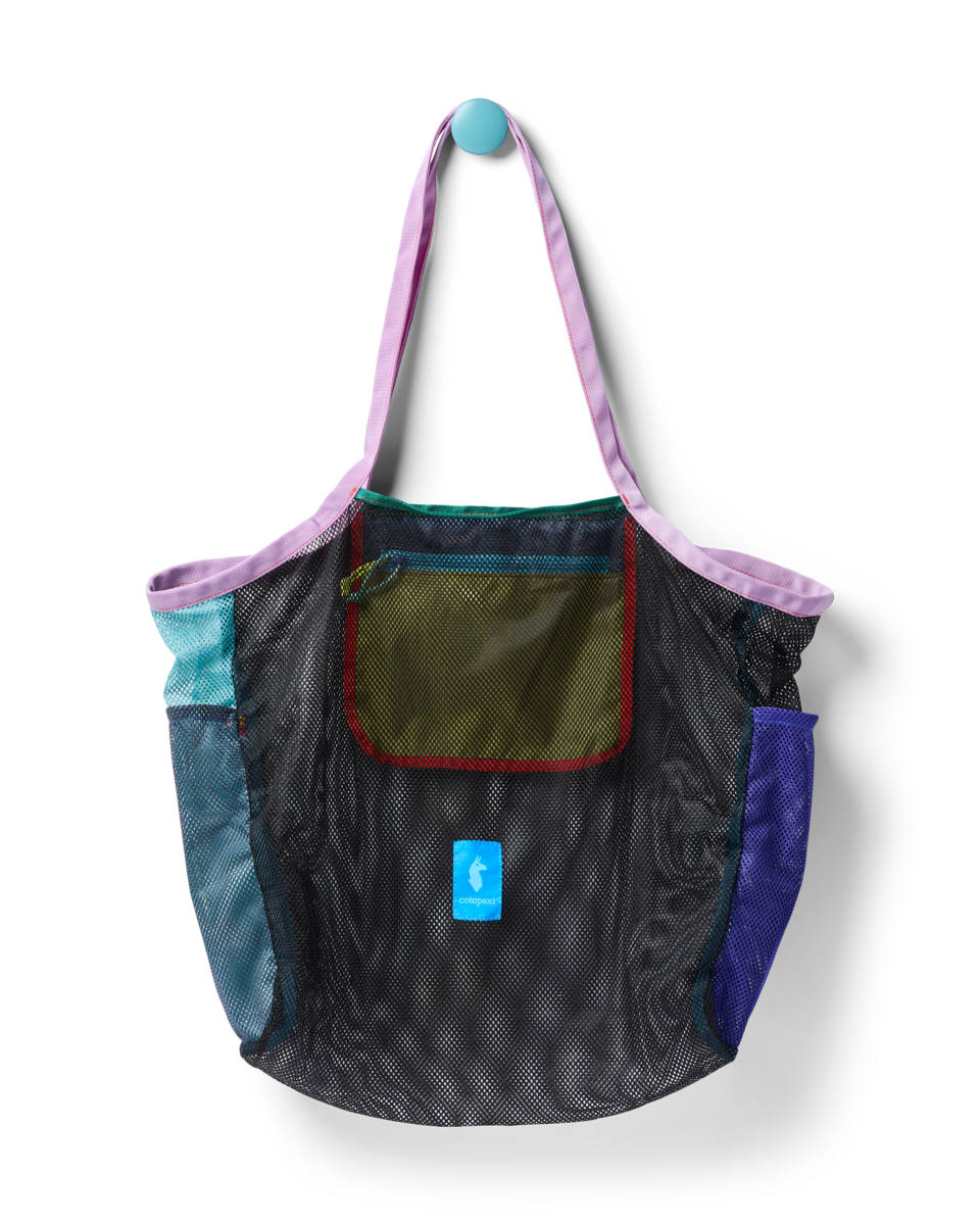Mesh tote bag with colorful fabric panels and shoulder straps hanging against white background