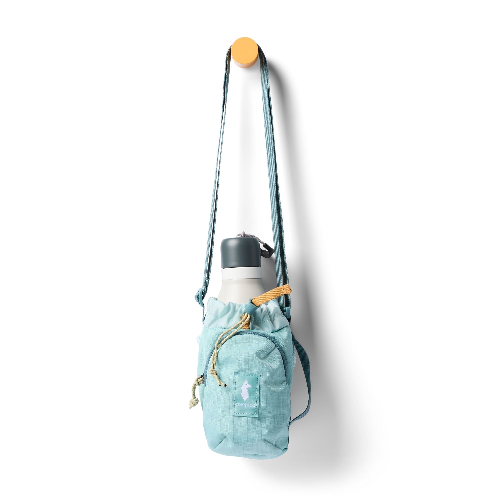 Light blue water bottle sling bag with crossbody strap, drawstring closure, and white insulated bottle