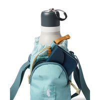 Water bottle sling bag holding a white insulated bottle and navy wallet, with crossbody strap