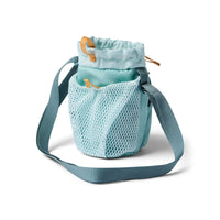 Aqua mesh drawstring bucket bag with adjustable crossbody strap and gold accent pulls, open top view