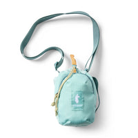 Small mint green crossbody sling bag with drawstring top, teal strap, and llama logo patch