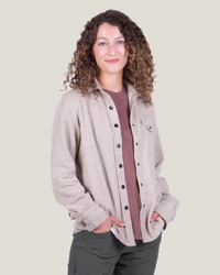 Women's fleece button-up shirt in light heathered tan, front view on model