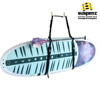 Paddleboard with carrying straps suspended horizontally showing decorative pattern and transport system