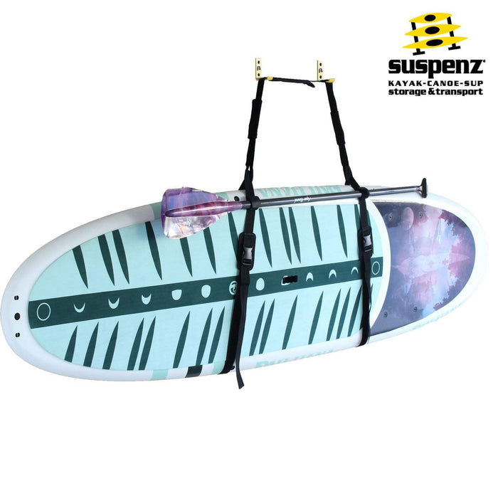 Paddleboard with carrying straps suspended horizontally showing decorative pattern and transport system