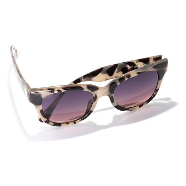 Tortoise shell patterned sunglasses with gradient purple lenses on white background