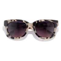 Cat-eye sunglasses with tortoiseshell pattern frame and dark gradient lenses on white background