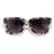 Cat-eye sunglasses with tortoiseshell pattern frame and dark gradient lenses on white background