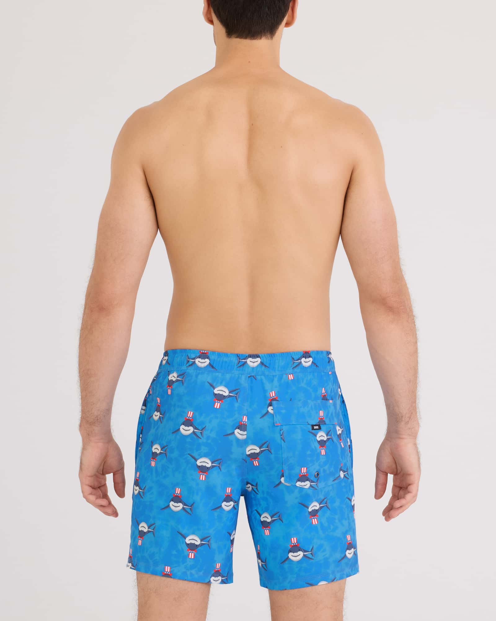 Men's swim trunks back view, blue with patriotic shark pattern, mid-thigh length
