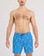 Men's blue swim trunks with patriotic shark pattern, drawstring waist, front view on model