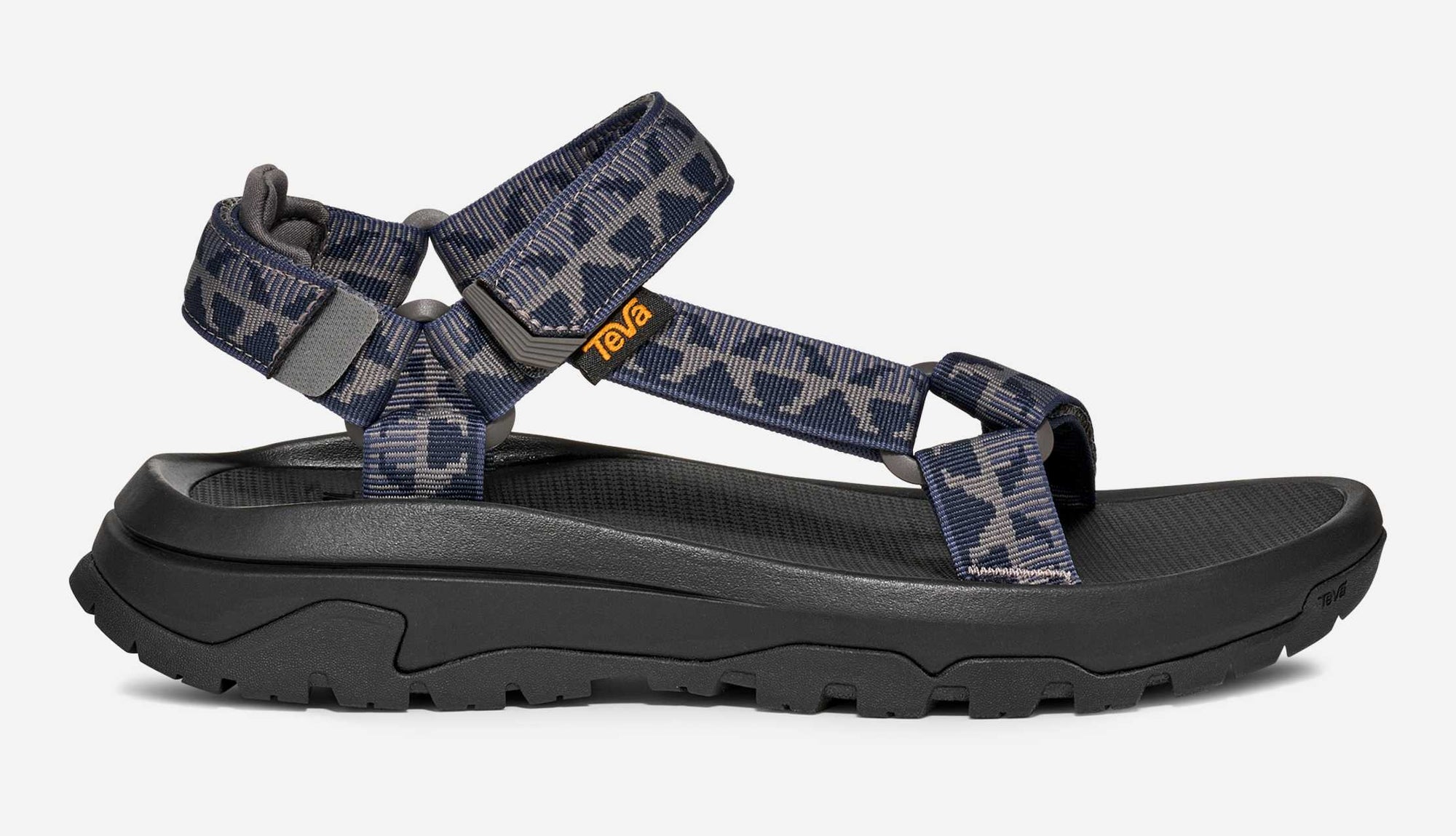 Sport sandal with navy and grey patterned straps and black sole, side profile view