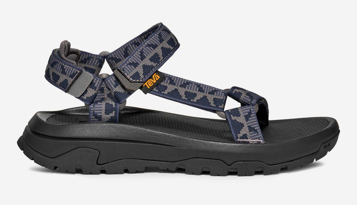Sport sandal with navy and grey patterned straps and black sole, side profile view