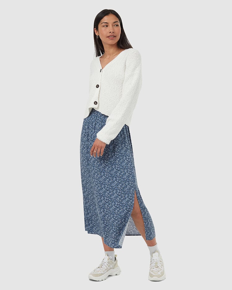 Cream ribbed knit cardigan with button front worn by woman in studio photo