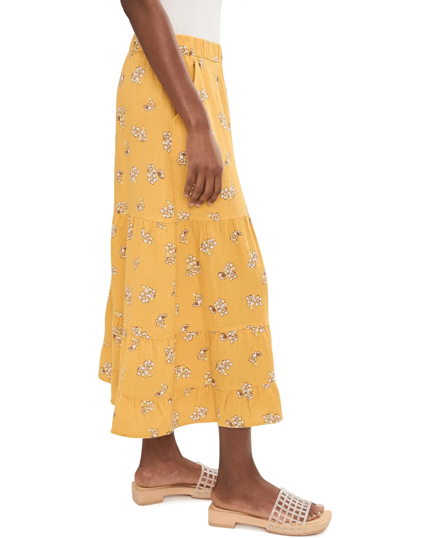 Yellow floral print palazzo pants with tiered ruffles worn with nude studded sandals