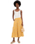 Woman wearing yellow floral palazzo pants with white tank top and woven bag