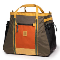 Large outdoor gear bag with orange front panel, brown body, and yellow trim straps