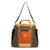 Multi-colored duffel bag with shoulder strap, front orange panel and dual handles