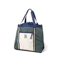 Large tote bag with drawstring top, color-blocked design featuring front zippered pocket