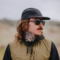 Square-framed sunglasses with dark lenses worn by person in outdoor lifestyle setting