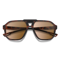 Folded aviator-style sunglasses with tortoise shell frame and amber photochromic lenses, front view