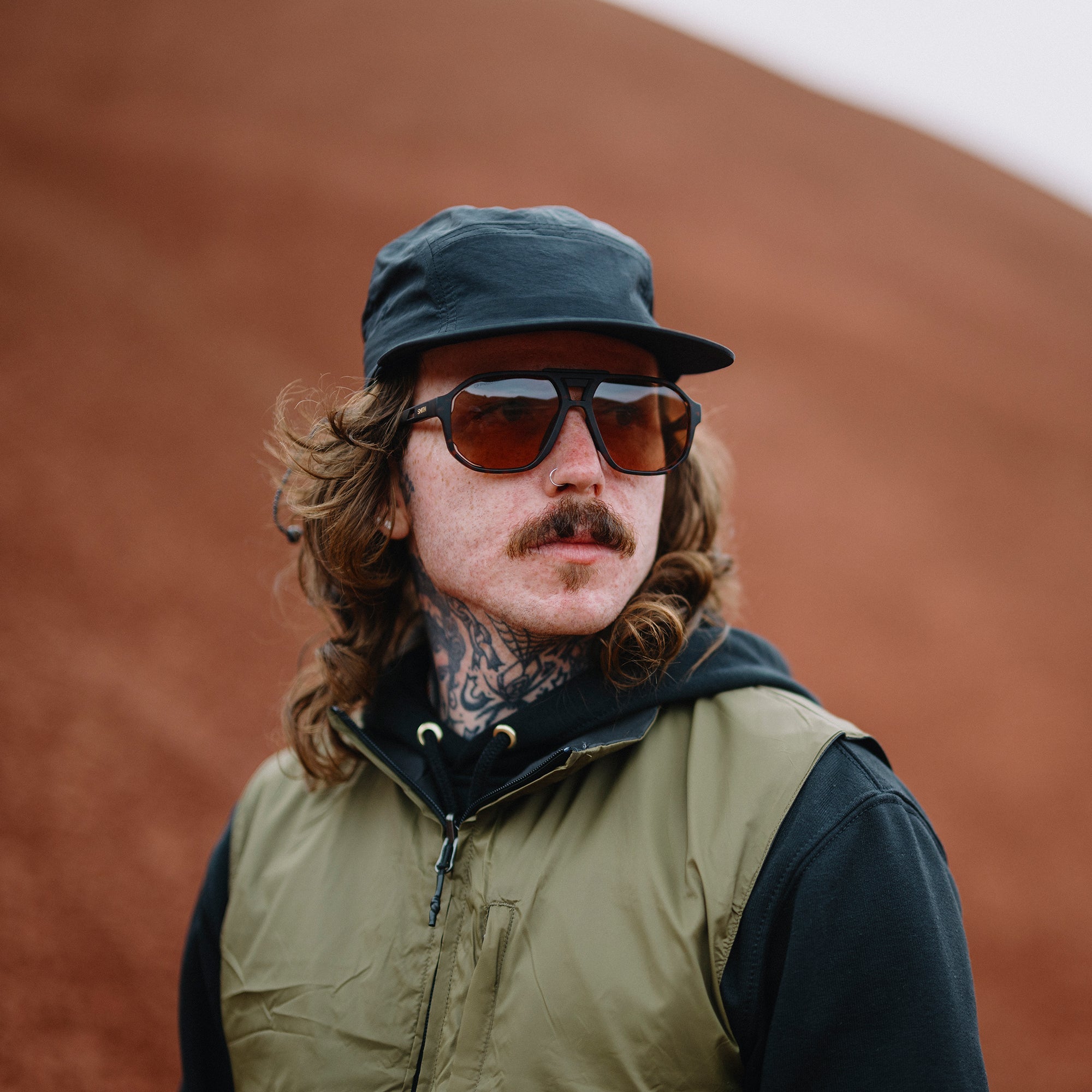 Oversized aviator-style sunglasses with tortoise frames and brown photochromic lenses, worn outdoors