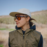 Lifestyle photo of oversized tortoise frame sunglasses with amber photochromic lenses worn outdoors