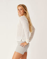 Women wearing cream colored mesh knit pullover sweater, side view showing relaxed fit