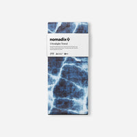 Blue tie-dye patterned ultralight travel towel in packaging with white label