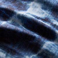 Blue and white tie-dye patterned ultralight towel with soft marbled texture, close-up detail view