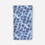 Blue patterned lightweight towel with water ripple design laid flat against white background