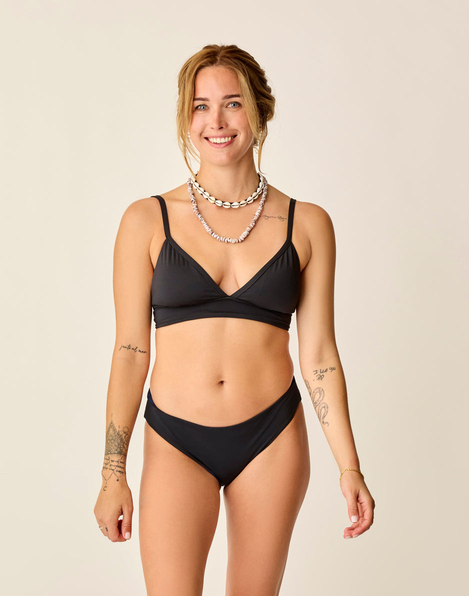 Black reversible bikini bottom shown on model with matching triangle top, front view