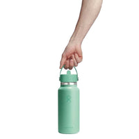Hand holding a wide-mouth insulated water bottle with flex straw cap and carry handle