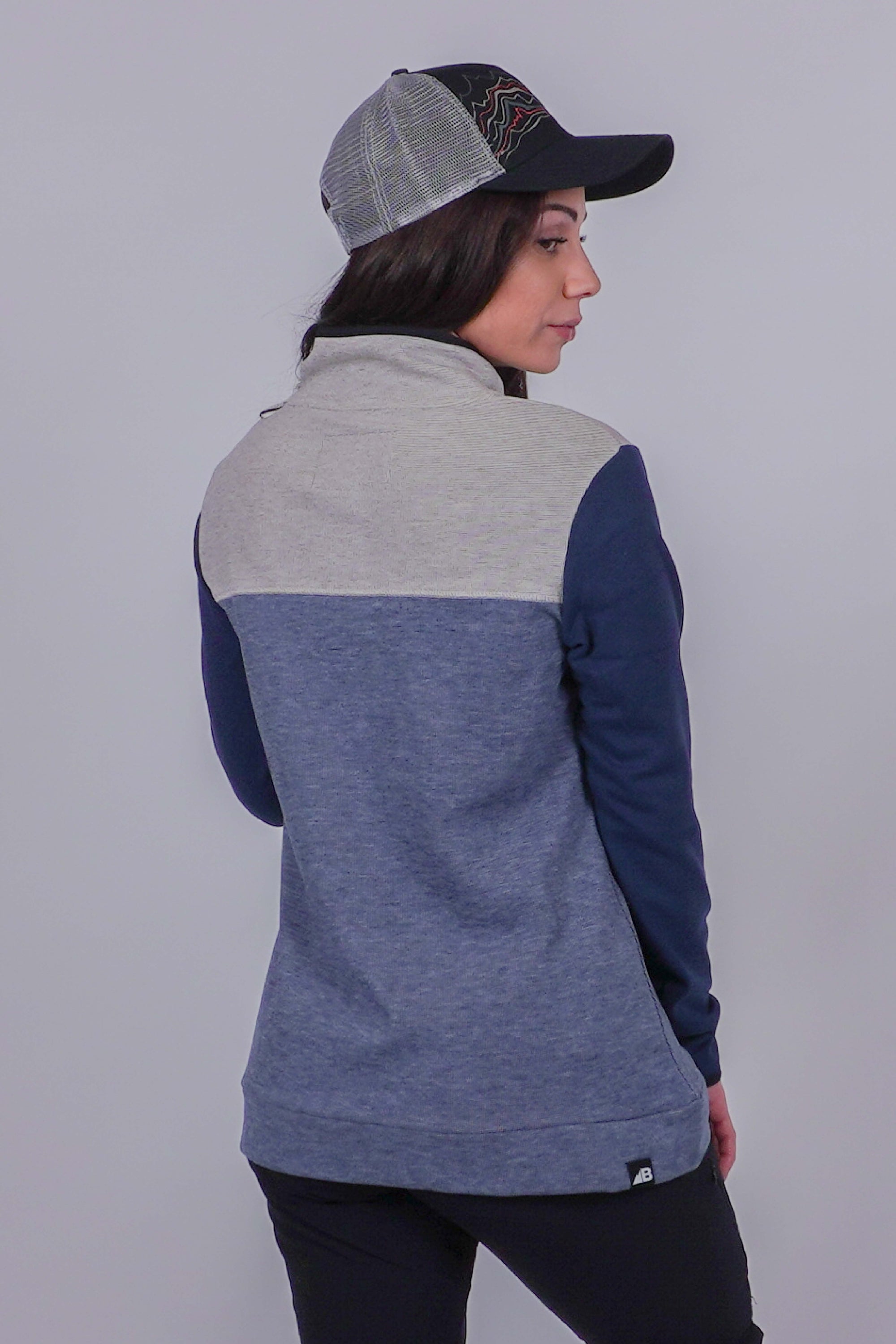 Women's color-block fleece pullover, back view, with gray, dusty blue, and navy panels